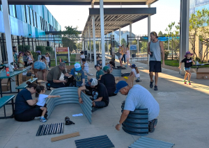 Parents and students volunteering together on campus